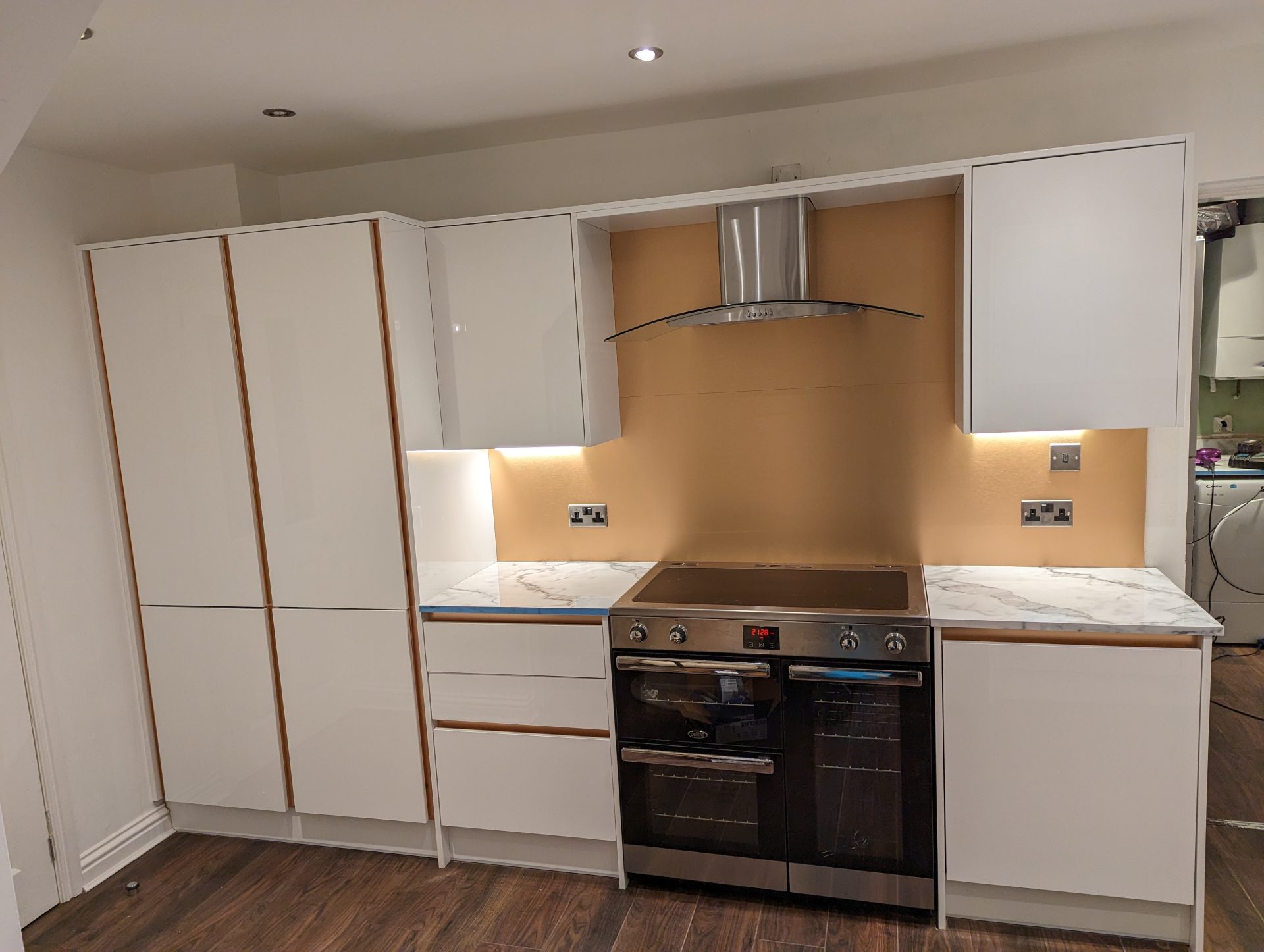 Minimalist kitchen with white cabinets and lights